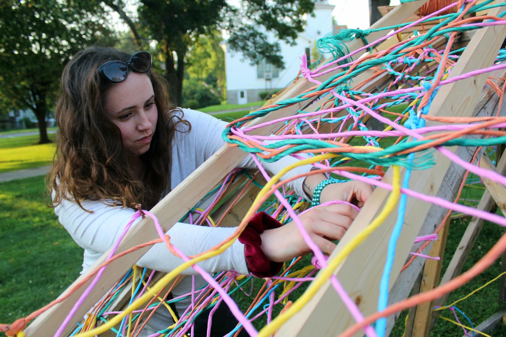 Alisa weaves twine into wildflower